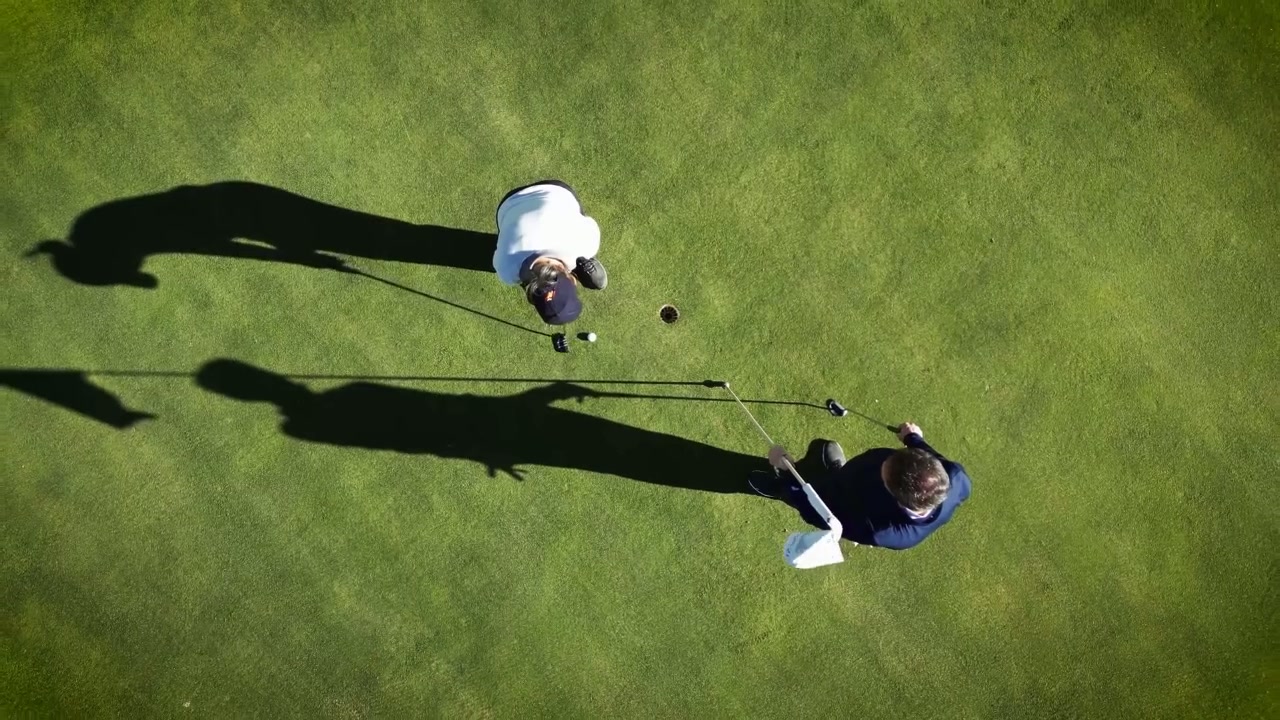 Overhead view of golfers on a putting green